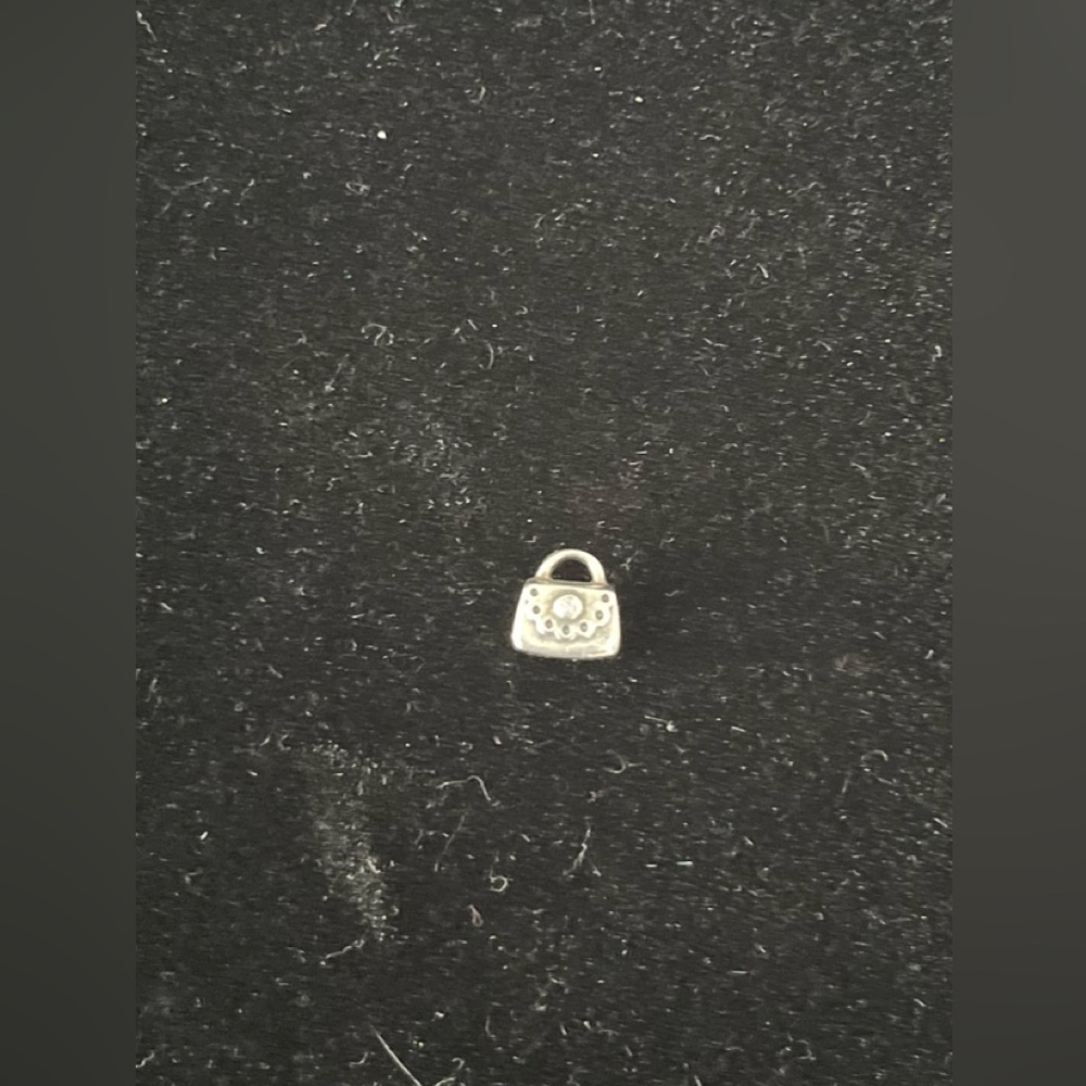 Pandora charm.  Retired purse with pink CZ crystal